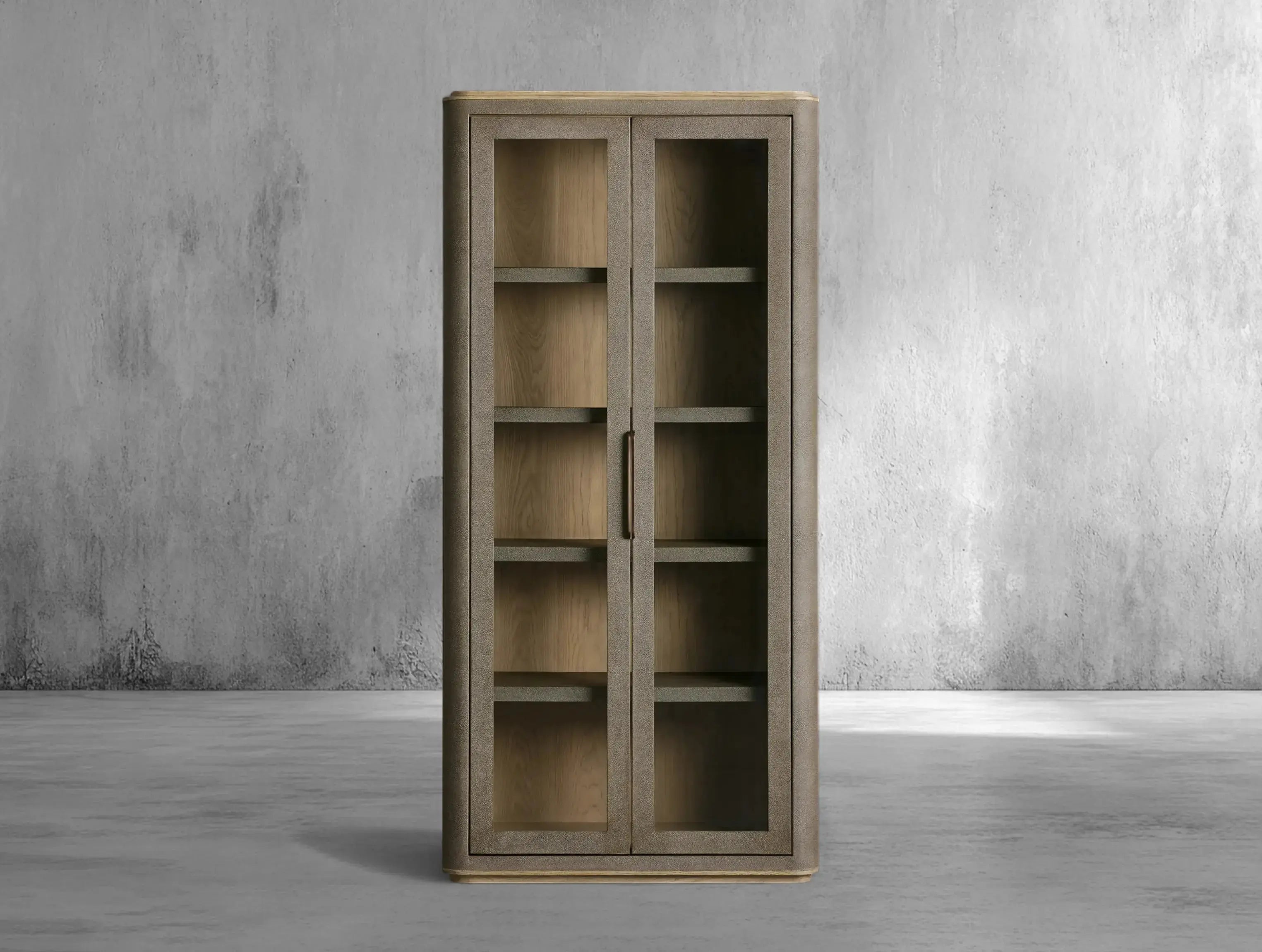 Wooden cabinet with glass doors against a gray concrete wall.